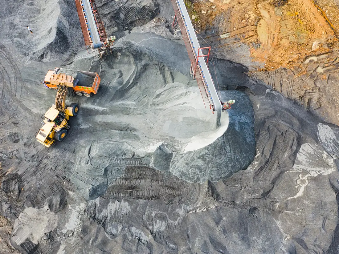 Aerial view of a loader filling a haul truck on a mine site