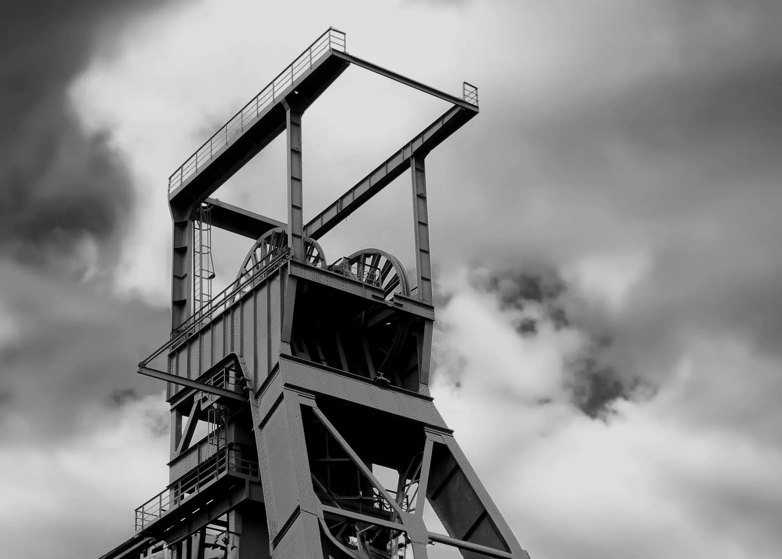 Steel mine headframe against a cloudy sky